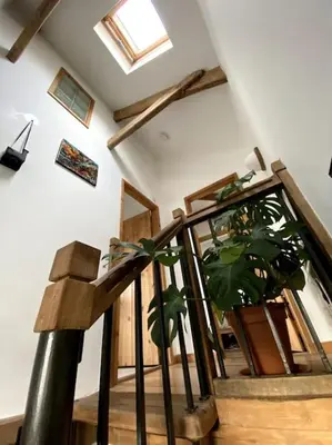 a staircase with a potted plant in a room at 9A Viaduct Cottage - the cosiest bolthole in the SW! in Hayle