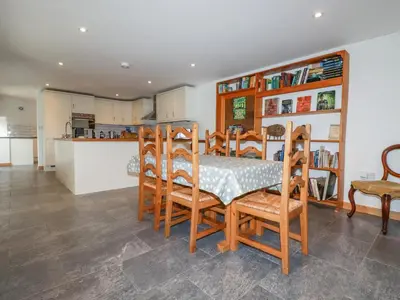 a kitchen and dining room with a table and chairs at The Orchard in Bodmin