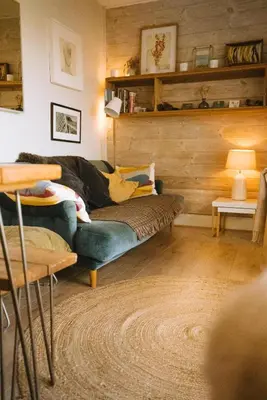 a living room with a couch and a table at Breathtaking Harbourside Views With Parking at 'Harbour Strand' in Falmouth