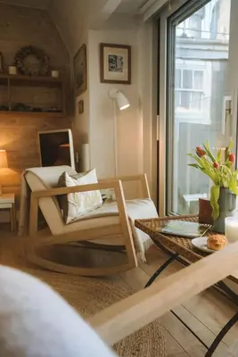 a living room with a chair and a table at Breathtaking Harbourside Views With Parking at 'Harbour Strand' in Falmouth