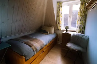 a small bedroom with a bed and a window at Breathtaking Harbourside Views With Parking at 'Harbour Strand' in Falmouth