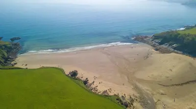 an aerial view of a beach and the ocean at The Vean in Mevagissey