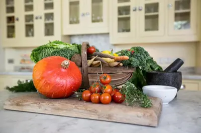 a table with a bunch of vegetables on a cutting board at The Vean in Mevagissey