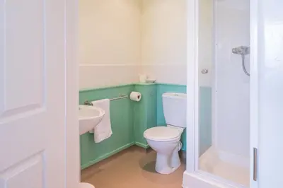 a bathroom with a toilet and a sink at Cosy room with golf & the beach on your doorstep! in Mawgan Porth