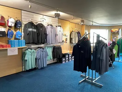 a store with a bunch of clothes on display at Cosy room with golf & the beach on your doorstep! in Mawgan Porth