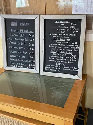 a chalk board with a menu on top of a table at Cosy room with golf & the beach on your doorstep! in Mawgan Porth