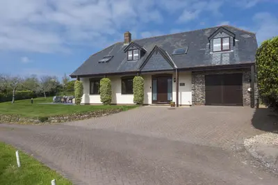 a house with a driveway in front of it at April Cottage in Polzeath