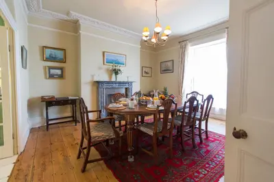 a dining room with a table and chairs at Captain's House Falmouth in Falmouth