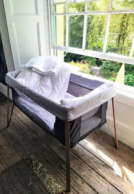 a bed in a room next to a window at Quay Street in Lostwithiel