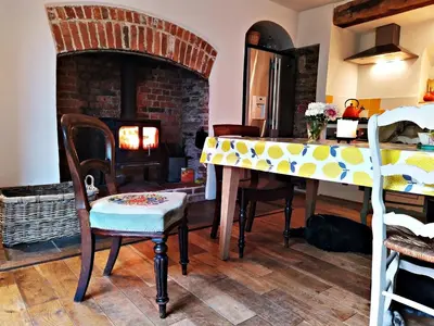 a living room with a table and a fireplace at Quay Street in Lostwithiel