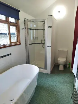 a bathroom with a bath tub and a toilet at Quay Street in Lostwithiel