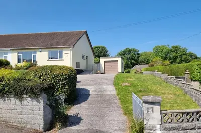 a driveway leading to a house with a garage at Cornish Village Getaway in Gwennap