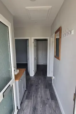 an empty room with a hallway with a sink and a room with at Cornish Village Getaway in Gwennap