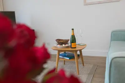 a table with a bottle of champagne and a bowl on it at Wavetop in St Ives