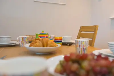a table with a bowl of bread and plates of food at Wavetop in St Ives