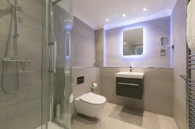 a bathroom with a toilet and a sink and a shower at Wavetop in St Ives