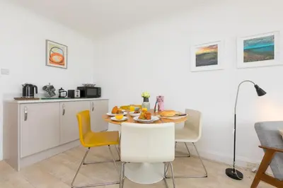 a kitchen and dining room with a table and chairs at 28 Carrack Widden in St Ives