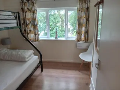 a bedroom with a bunk bed and a window at 78 Atlantic Reach in Newquay