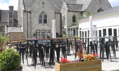 a group of chairs and tables in front of a building at 78 Atlantic Reach in Newquay