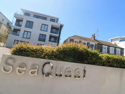 a sign for a realestate sign in front of a building at Newquay, Beach Charm and Town Vibes with Parking in Newquay