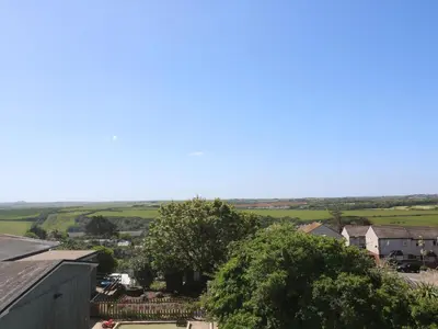 an aerial view of a small town with trees and houses at Newquay, Beach Charm and Town Vibes with Parking in Newquay