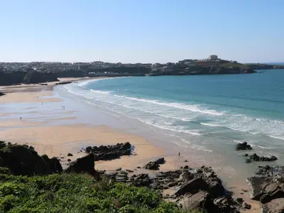 a view of a beach with rocks and the ocean at Newquay, Beach Charm and Town Vibes with Parking in Newquay