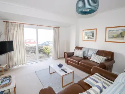 a living room with a couch and a table at Waverley in St Austell
