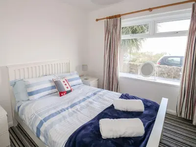 a bedroom with a bed with two pillows on it at Waverley in St Austell