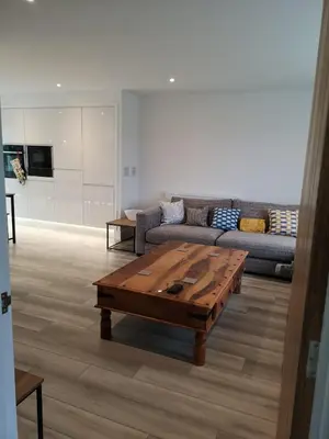 a living room with a couch and a coffee table at Cornish Coastal Bungalow in Padstow