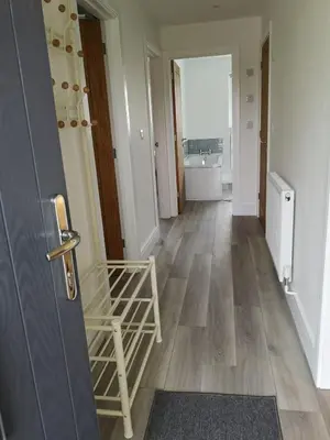 a hallway with a door and a room with a bathroom at Cornish Coastal Bungalow in Padstow