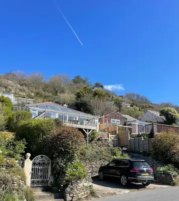 a car parked on the side of a road at Mesmerising sea views - Penrose - above the beach Cornwall. in Downderry