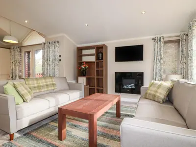 a living room with a couch and a table at Haven Lodge in Tintagel