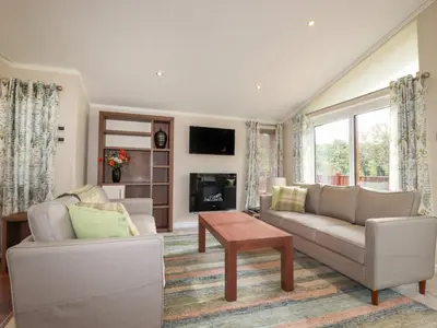 a living room with a couch and a table at Haven Lodge in Tintagel