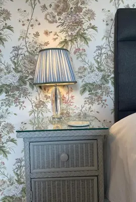 a lamp on a night stand next to a bed at Treveighan Farmhouse in Saint Teath