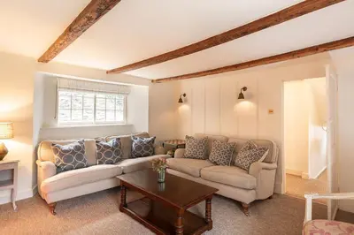 a living room with a couch and a table at The Manor House in Port Isaac