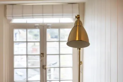 a lamp in front of a door with a window at The Manor House in Port Isaac