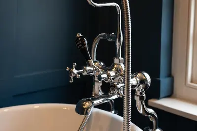 a bathroom with a bath tub with a shower at The Manor House in Port Isaac