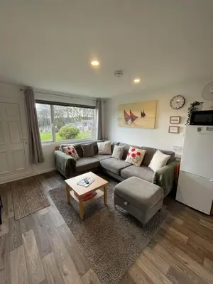 a living room with a couch and a table at Villa 22 Lanteglos Hotel in Lanteglos