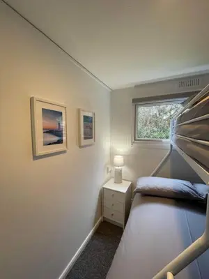 a bedroom with a bunk bed and a window at Villa 22 Lanteglos Hotel in Lanteglos