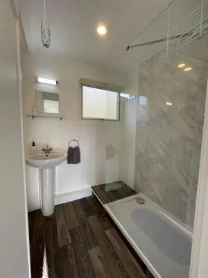 a bathroom with a shower and a sink and a tub at Villa 22 Lanteglos Hotel in Lanteglos