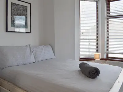 a bedroom with a bed with a pillow on it at Crantock House in Newquay