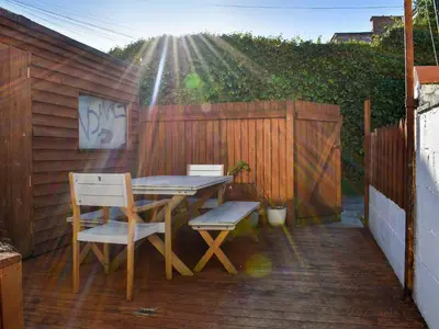 a patio with a table and chairs and a fence at Crantock House in Newquay