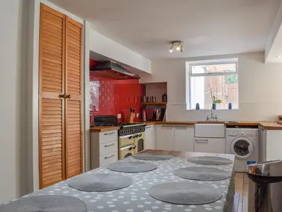 a kitchen with a table with four circular plates on it at Crantock House in Newquay