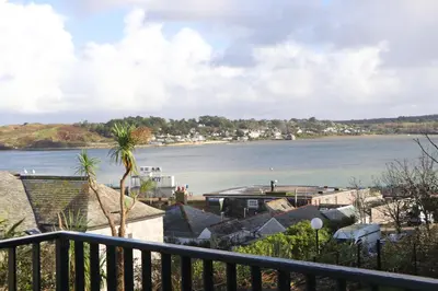 a view of a body of water from a balcony at Stylish estuary view apartment in Padstow