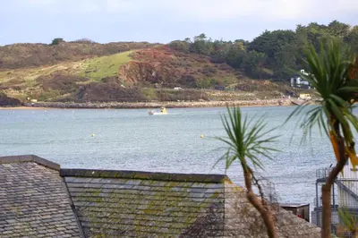 a view of a body of water with a boat in it at Stylish estuary view apartment in Padstow