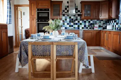a kitchen with a table with blue and white dishes on it at Beautiful Cornish Home 
