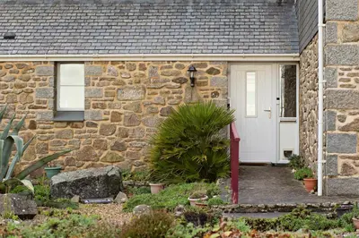 a stone house with a white door at Beautiful Cornish Home 