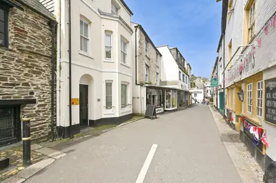 an empty street in a city with buildings at Captain's House Looe in Looe