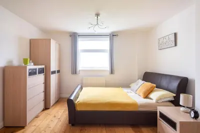 a small bedroom with a bed and a window at Hibiscus house in Newquay