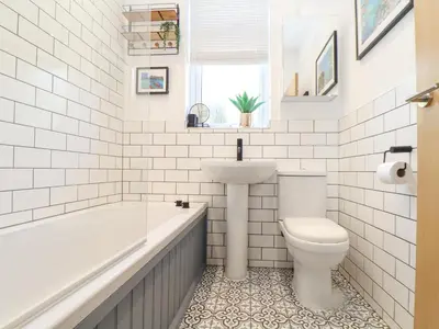 a bathroom with a tub and a toilet and a sink at Higher Bolenna in Perranporth